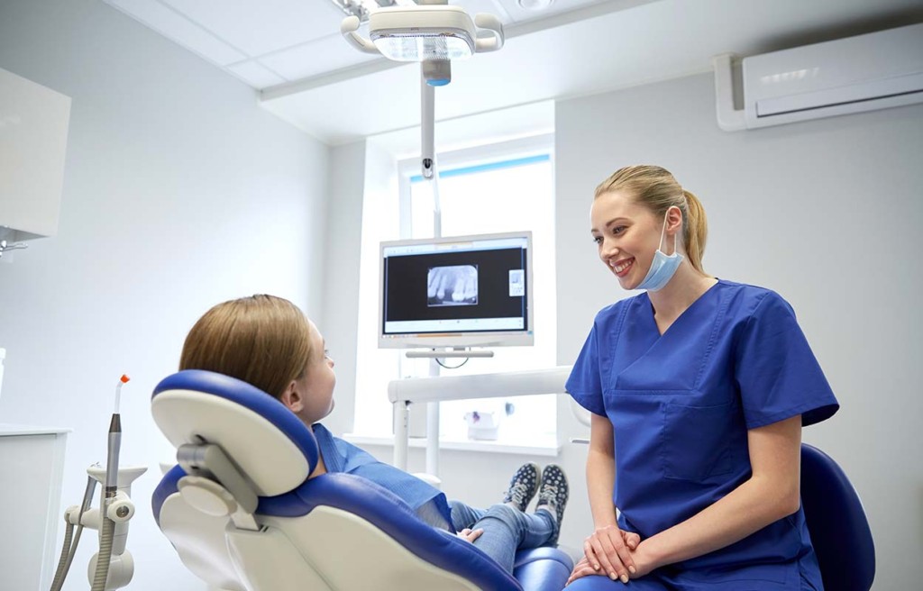  Female Dentist With Patient Girl In Remote Dental Clinic