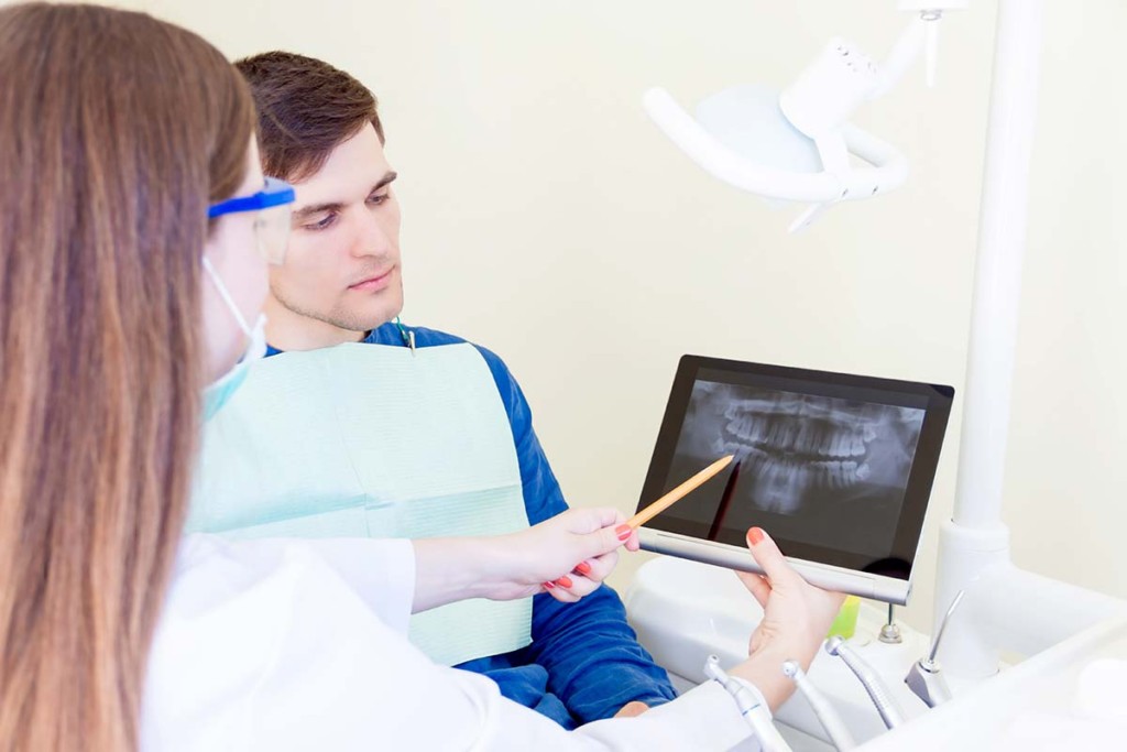  Dentist With X Ray Of Patient Teeth Inside Mobile Dental Unit
