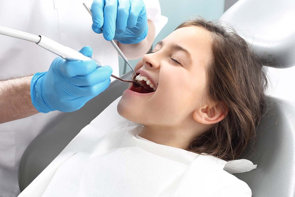  Child Getting Tooth Filling Inside Mobile Dental Unit