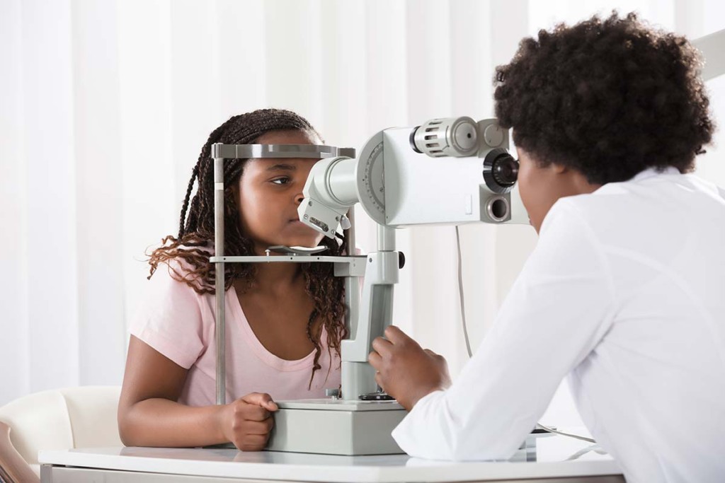  Optometrist Examining Patient On Phoropter Inside Mobile Ophthalmology Clinic