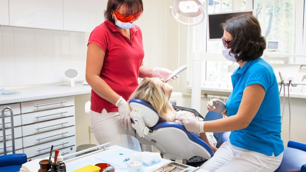  Patient Receiving Dental Curing Ultraviolet Light Inside Mobile Dental Unit