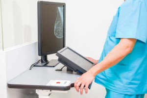 Doctor Looking At Mammogram Inside Womens Health Clinic