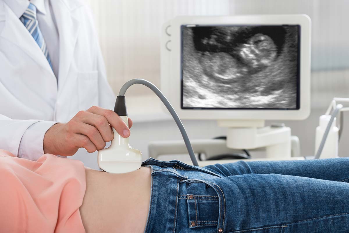 Doctor Moving Ultrasound Probe On Pregnant Woman Inside Mobile Ob Gyn ...