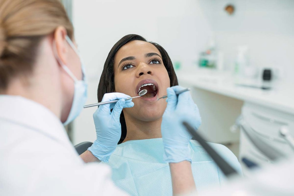  Dentist Examining Teeth Inside Mobile Dental Clinic