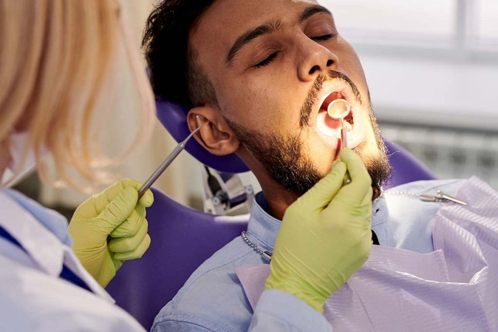  Dentist Performing Examination Inside Mobile Dental Outreach Facility