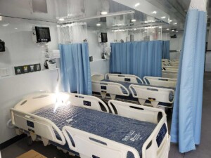 Row of beds with blue privacy curtains
